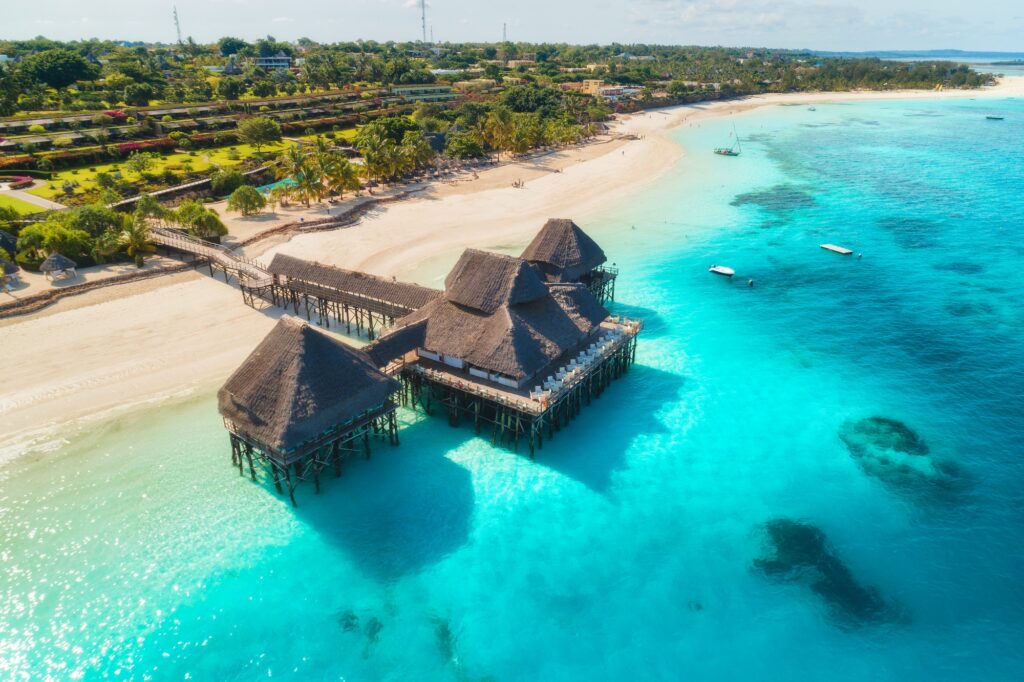 Aerial view of beautiful hotel on the water in ocean at sunset