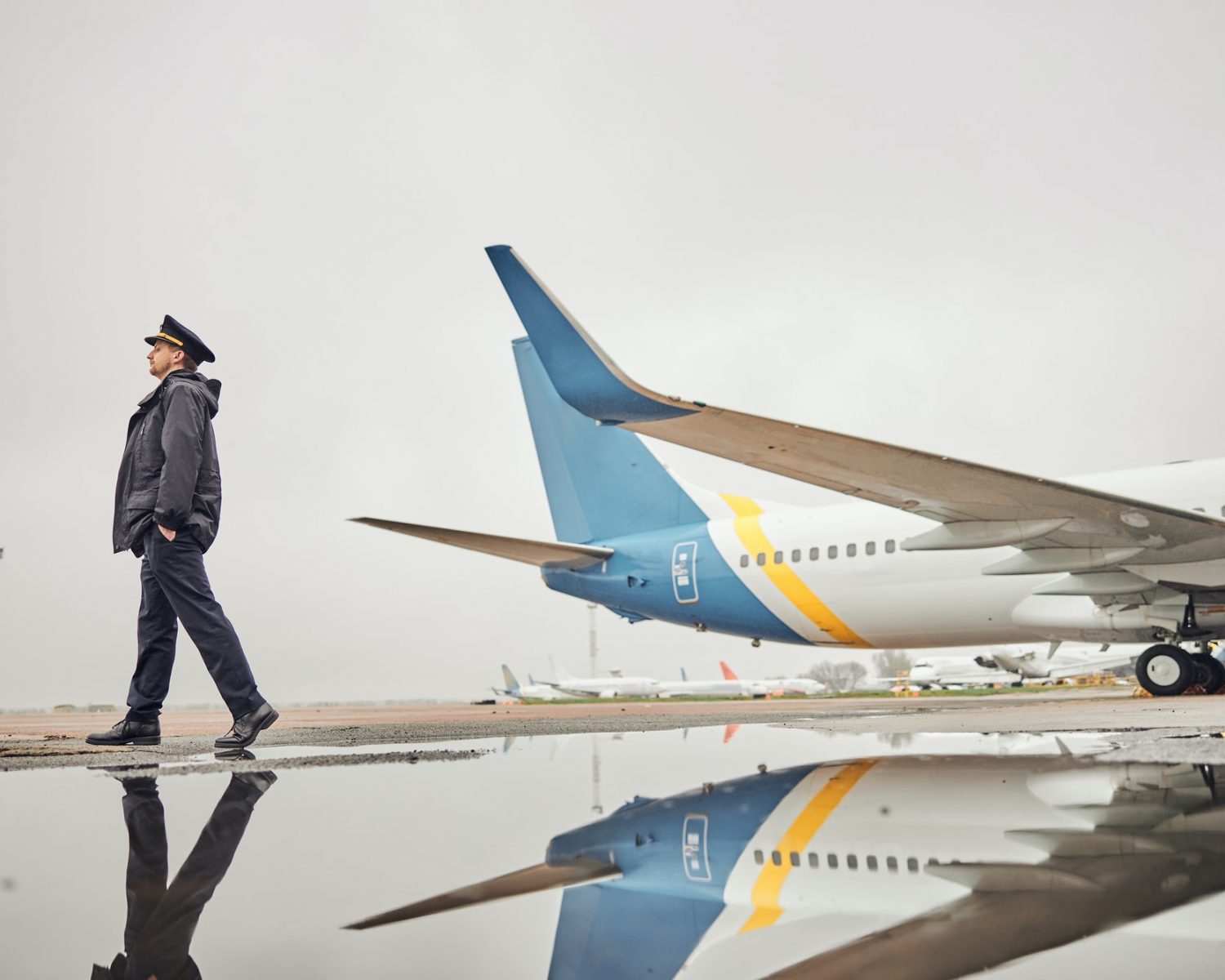 Portrait of happy confident caucasian airplane crew near plane